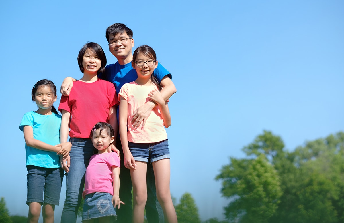 Asian children standing in the sun