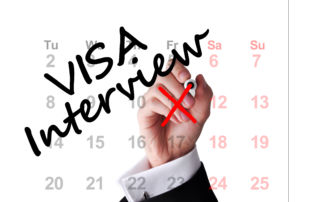 a hand writing visa interview on a calendar