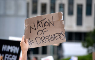 a hand holding a sign reading nation of dreamers