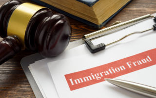 a gavel next to papers labeled immigration fraud